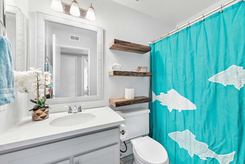 Floating shelves crafted from liquidambar wood in a remodeled Mission Viejo condo bathroom