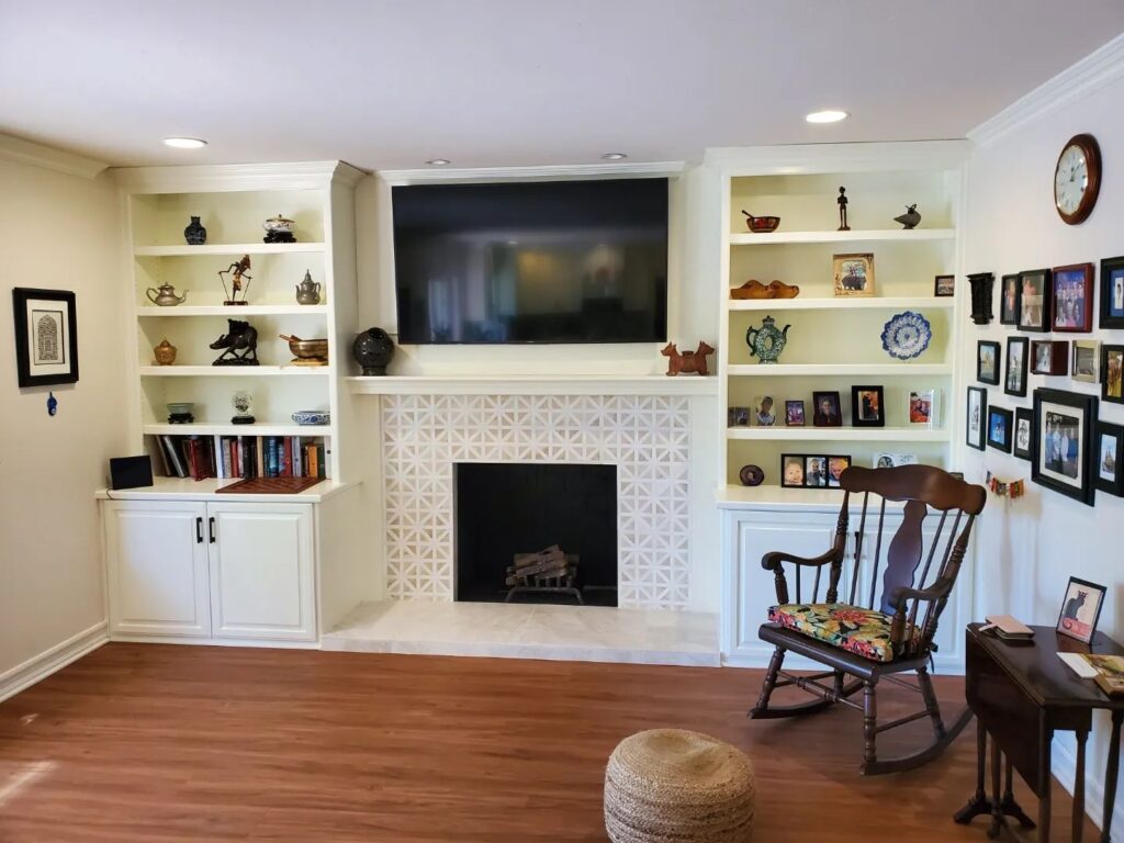 Custom fireplace mantle rebuild with white built-ins and geometric tile surround in Huntington Beach, CA.